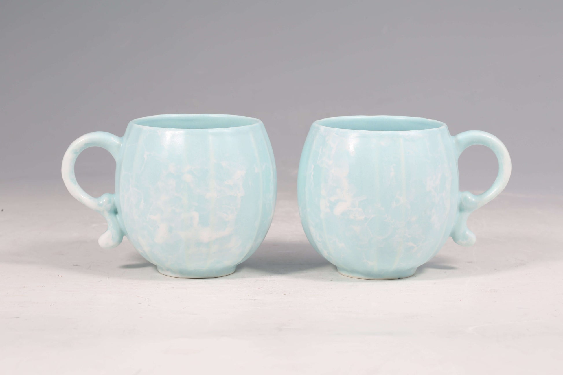 Mavolux handcrafted porcelain mug set in azure blue with a smooth satin-glaze finish. Playful pumpkin-shaped coffee cup made in Yingge Taiwan, creating a cozy and joyful atmosphere.