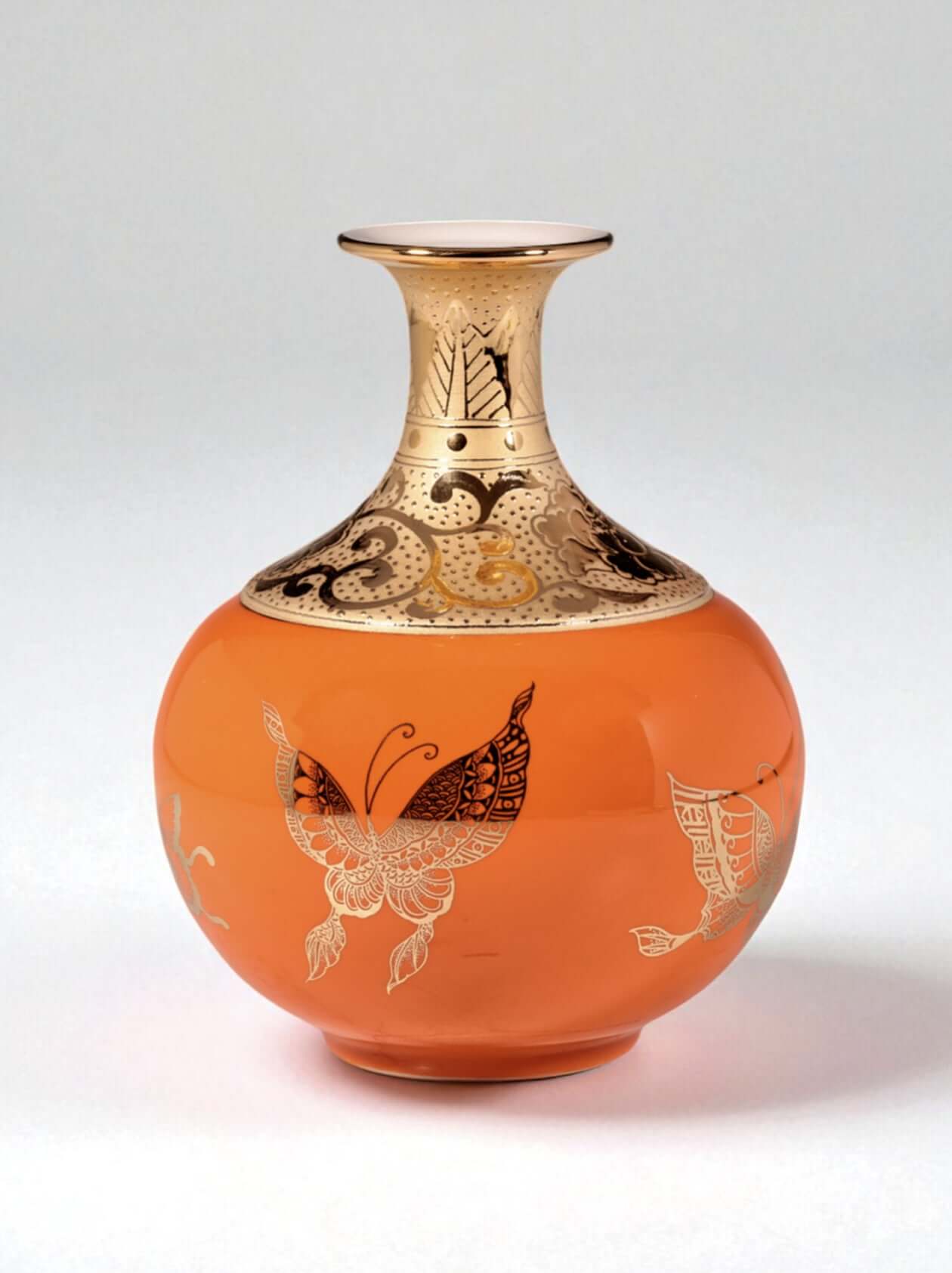 Mavolux handcrafted porcelain vase in vibrant orange glaze featuring delicate butterfly motifs and 24K gold gilding. Luxury ceramic centerpiece made in Yingge Taiwan, creating a warm and elegant atmosphere.